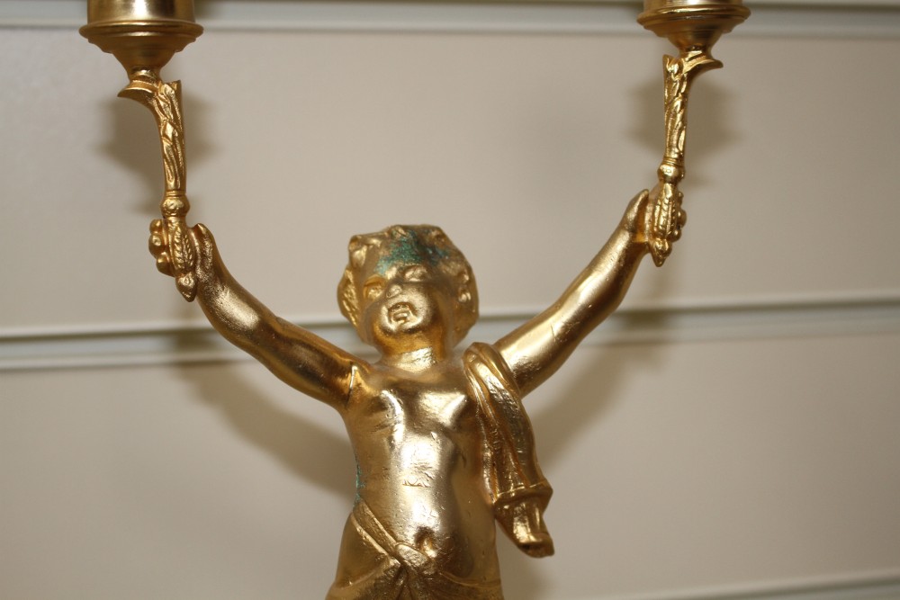 A pair of Italian gilt metal candelabra, with putto stems and marble bases, height 51cm